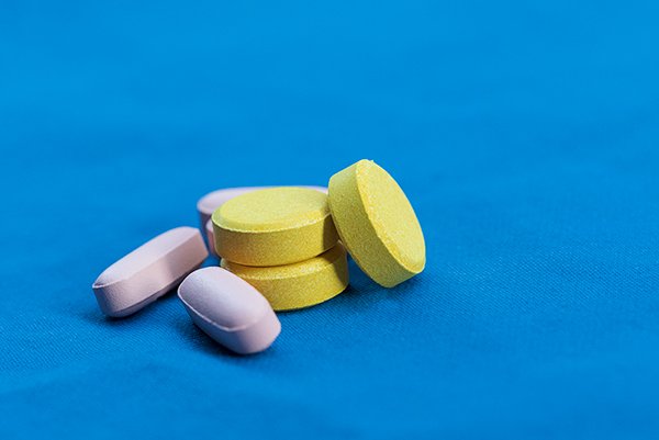 yellow and pink medicine on a blue cloth