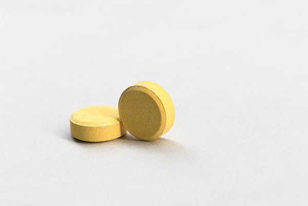 Yellow colored medicine with white background