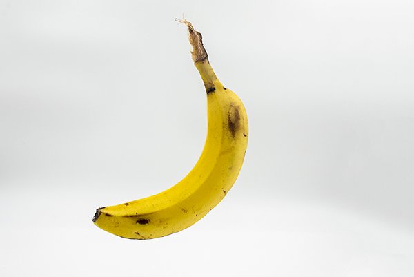 a closeup of a banana in a white background