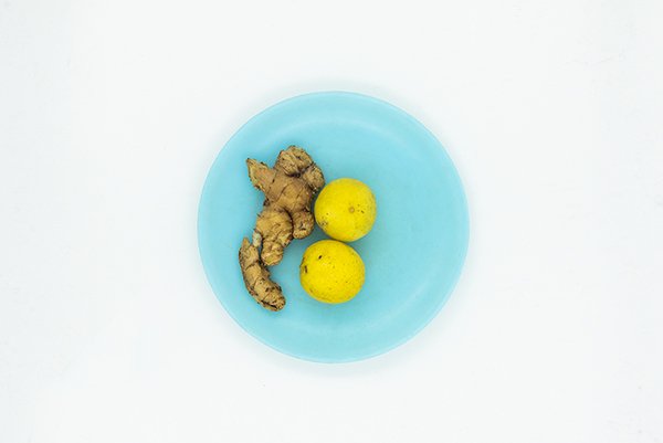 a blue plate with ginger and lemon