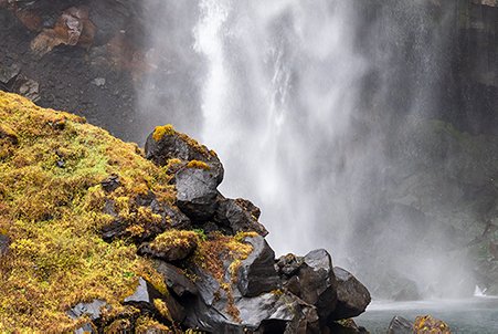 stones and waterfall behind