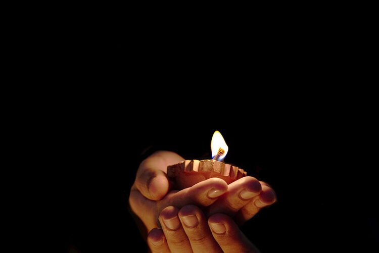 hands holding diya