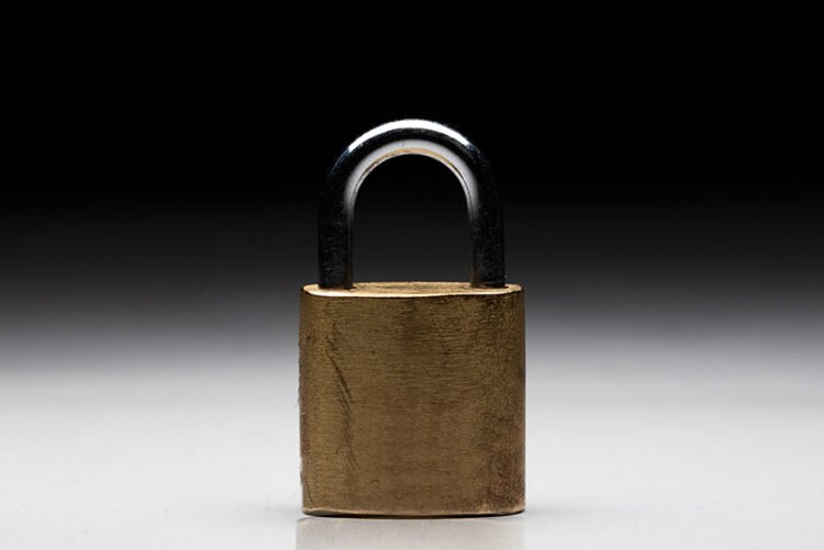 a close up of a pad lock with a white and black background.