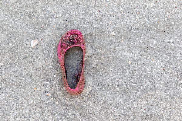 an old baby shoe near the beach area.