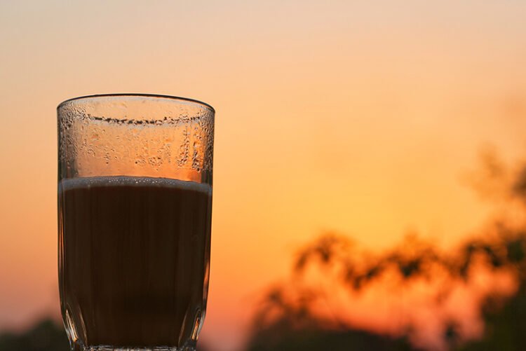 A hot tea glass during the sunset