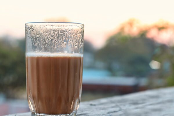 a glass filled with hot tea